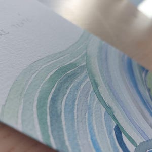 Gepersonaliseerde kaart geschilderd in waterverf, blauwe en groene golven, zee.
