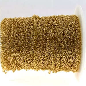 May include: A spool of gold-colored chain, perfect for jewelry making or crafting projects.