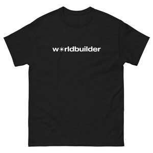 May include: Black t-shirt with the white text "worldbuilder" printed across the chest. The word "worldbuilder" is in a sans-serif font. The letter "o" in "world" is replaced with a star symbol. The t-shirt has short sleeves and a crew neck.