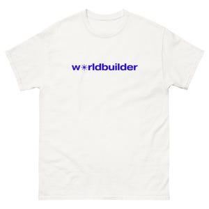 May include: White t-shirt with the word "worldbuilder" printed in blue. The word "worldbuilder" is in a sans-serif font. The letter "o" in "world" is replaced with a star symbol.