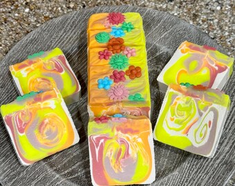 Wildflower and honey soap bars embellished, with flower embeds, feature delicate vibrant double drop swirls.