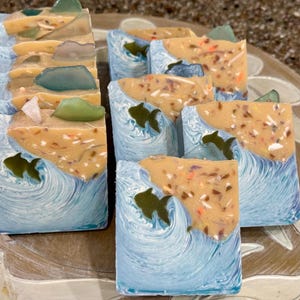 Ocean shore scented small batch, hand made soap bars, with an ocean design, including a fun fish embed, topped with soapy sea glass