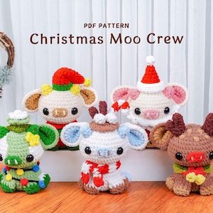 May include: A collection of five crocheted Christmas-themed cow figurines. Each cow is uniquely designed with festive hats, scarves, and decorative elements. The text "Christmas Moo Crew" is displayed above the figurines.