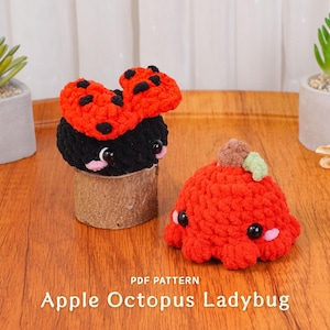 May include: Two handmade crochet plush toys: a black ladybug with a red spotted bow and a red apple-shaped octopus. The toys have black eyes and are on a wooden surface. The text "Apple Octopus Ladybug" is visible.
