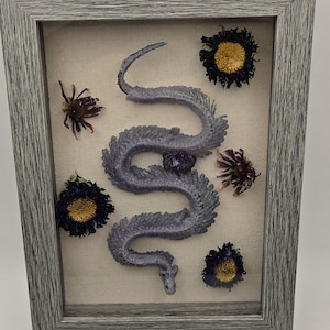 Real crystallized snake skeleton in frame