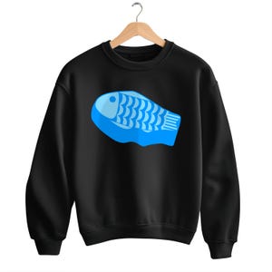May include: Black sweatshirt with a blue fish graphic on the front.