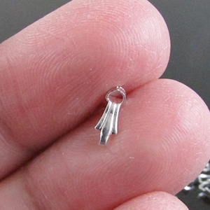 May include: Silver-toned metal clasp with a decorative, pointed design. The clasp is designed to be used for jewelry making.