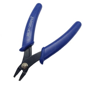 May include: A pair of micro crimper pliers with blue handles and black jaws. The text "MICRO CRIMPER" is printed on one handle. The tool is designed for precision work.