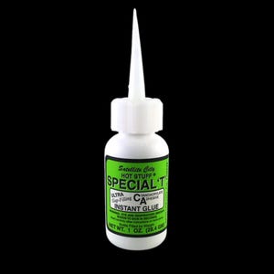 May include: A white bottle of Satellite City Hot Stuff Special T instant glue. The bottle has a green and white label with product information and a long, pointed applicator tip. Net weight is 1 oz.