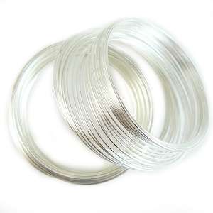 May include: A stack of silver wire rings, perfect for jewelry making or crafting.