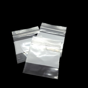 May include: Three clear plastic zippered bags with a white opaque panel. The bags are stacked on top of each other.