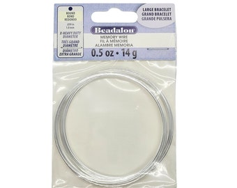 May include: A roll of silver memory wire, 0.5 oz (14 g), for making bracelets. The packaging says "Beadalon Memory Wire, Fil a Mémoire, Alambre Memoria, Large Bracelet, Grand Bracelet, Grande Pulsera, Round, Rond, Redondo, X-Heavy Duty Diameter, Très Grand Diamètre, Diámetro Extra Grande".