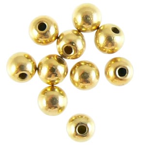 May include: A group of ten gold-colored round beads with a hole in the center. The beads are scattered on a white background.