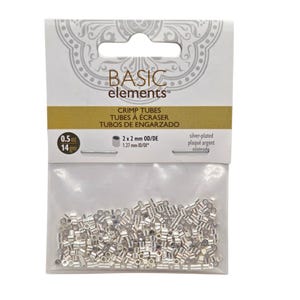 May include: A clear plastic bag containing a large quantity of small, silver-plated crimp tubes. The packaging is labeled Basic Elements and specifies a weight of 0.5 oz, with dimensions of 2 x 2 mm OD and 1.27 mm ID printed on the header card.
