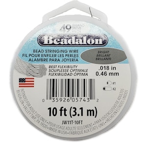 May include: A spool of Beadalon bead stringing wire. The package is white with blue accents and features text in English, French, and Spanish. The wire is 10 ft (3.1 m) long and .018 in (0.46 mm) thick. Includes the American flag.