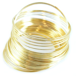 May include: A stack of gold-colored wire rings, perfect for crafting jewelry or other projects.