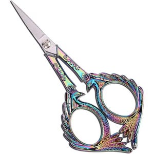 May include: Iridescent peacock-themed scissors with sharp, silver blades. The handles feature a colorful, ornate design with a peacock motif. The scissors are designed for crafting and sewing projects.