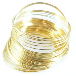 May include: A stack of gold-colored wire rings, perfect for crafting jewelry or other projects.