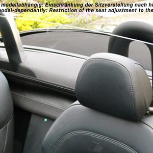 May include: A clear plastic wind deflector for a convertible car. The deflector is fitted behind the front seats and is designed to reduce wind noise and drafts.