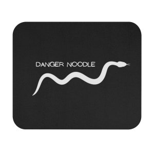May include: Black mouse mat with a white snake and the text "DANGER NOODLE" on it.