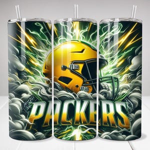 May include: Green and gold stainless steel tumbler featuring a football helmet and the word "PACKERS" printed on it. The background is a green and yellow design with smoke and lightning bolts.