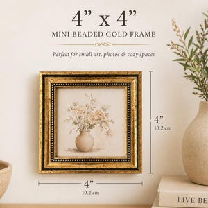 May include: A square, gold-framed picture with a beaded edge, measuring 4 inches by 4 inches. The artwork inside depicts a vase of flowers. Text on the frame reads "MINI BEADED GOLD FRAME" and "Perfect for small art, photos & cozy spaces."