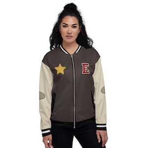 May include: A brown bomber jacket with a yellow star and a red "E" on the front. The jacket has white sleeves with a gray patch on the elbow.