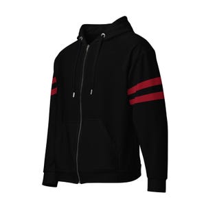 May include: Black zip-up hoodie with red stripes on the sleeves.