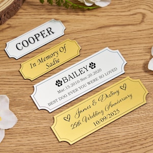 May include: Four personalized metal plaques with decorative edges. One reads "COOPER", another "In Memory of Sadie", a third "BAILEY" with dates and a paw print, and the last "James & Destiny 25th Wedding Anniversary".