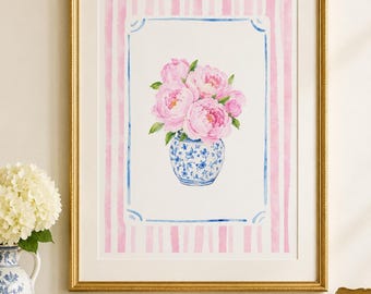 May include: A framed watercolour print showing a bouquet of pink peonies in a blue and white vase. The artwork is set against a background of pink and white stripes, framed in gold. The overall theme is floral and decorative.