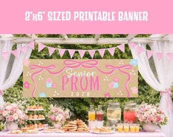 May include: A pink and brown banner with the text "Senior PROM 2026" is displayed at an outdoor event. The banner is 0.6 meters by 1.8 meters. The scene includes a table with food and drinks, and pink and white decorations.
