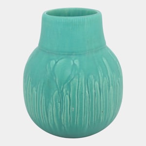 May include: A turquoise ceramic vase with a rounded body and a narrow neck. The vase features a textured surface with vertical lines and a stylized floral design. The vase is approximately 6 inches tall.