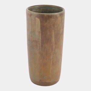 May include: A tall, cylindrical vase with a rustic, earthy aesthetic. The vase has a mottled brown and tan color scheme with a hint of green at the rim. The surface has a textured appearance, suggesting a handcrafted or artisanal quality.