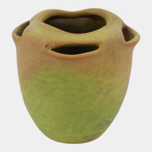 May include: A ceramic vase with a matte finish, featuring a gradient of lime green at the base transitioning to a muted tan at the top. The vessel has a rounded body with a textured surface and three distinct openings along the upper rim.