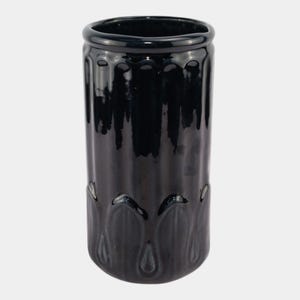 May include: A tall, glossy black ceramic vase with a cylindrical shape. The vase features vertical, ridged detailing along its body and a decorative, tear-drop shaped design at the base. The top rim is smooth and rounded.