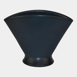 May include: A dark blue, ceramic vase with a unique, flared shape. The vase has a wide, curved top and tapers down to a rounded base. The overall design is modern and minimalist, suitable for displaying flowers or as a decorative piece.