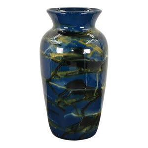 May include: A blue ceramic vase with a marbled design in shades of yellow, green, and black.