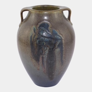 May include: A brown ceramic vase with two handles and a dark blue grape design. The vase has a glossy finish and a rounded shape, with a dark blue base and a green interior.