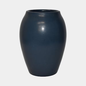 May include: A navy blue ceramic vase with a glossy finish. The vase has a rounded body and a slightly flared opening. The smooth surface reflects light, highlighting its elegant shape. This decorative vase is suitable for displaying flowers or as a standalone accent piece.