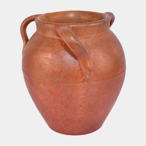 May include: A terracotta-colored ceramic pot with two curved handles. The pot has a rounded body and a wide opening. The surface has a slightly rough texture and variations in color, suggesting a handmade or rustic aesthetic. The pot is likely used for storage or decoration.