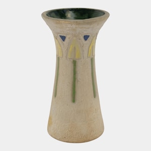 May include: A beige ceramic vase with a flared top and a wide base. The vase features a dark green interior and is decorated with yellow and green floral designs. Blue triangles accent the top. The vase is approximately 8 inches tall.
