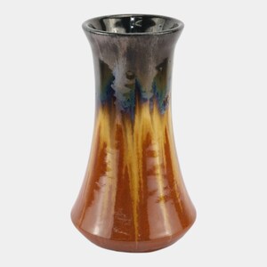 May include: A handcrafted ceramic vase with a flared base and a narrow neck. The vase features a glossy finish with a gradient of colors, including brown, yellow, blue, and black. The vase is approximately 8 inches tall.