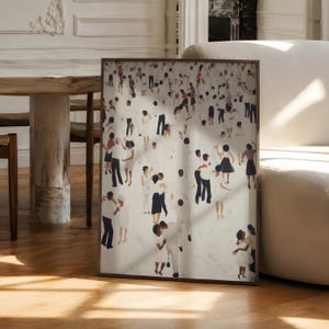 Large unframed print leaning by dining table, sunlight on neutral abstract with tiny people dancing print