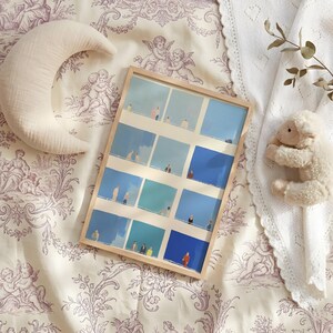Flat lay on floral fabric, Tiny People Wall Art in simple frame, soft blues and creams, whimsical abstract download