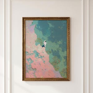May include: A framed wall art print featuring a small white astronaut figure standing on the edge of a textured, abstract landscape. The background consists of blended patches of soft pink, muted teal, and deep blue tones in a gold frame.