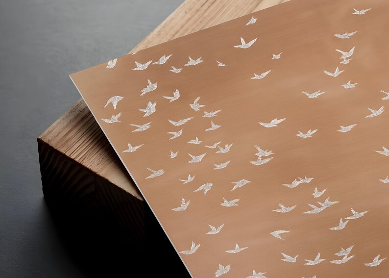a close-up view of a wooden surface with a repeating pattern of white birds.