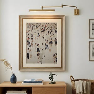 Gold frame above mid century modern sideboard, neutral abstract with playful tiny people dancing print, music lover wall art