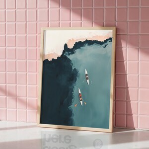 Leaning framed print against blush pink tile, aerial teal lake with rowers, rowing wall art printable