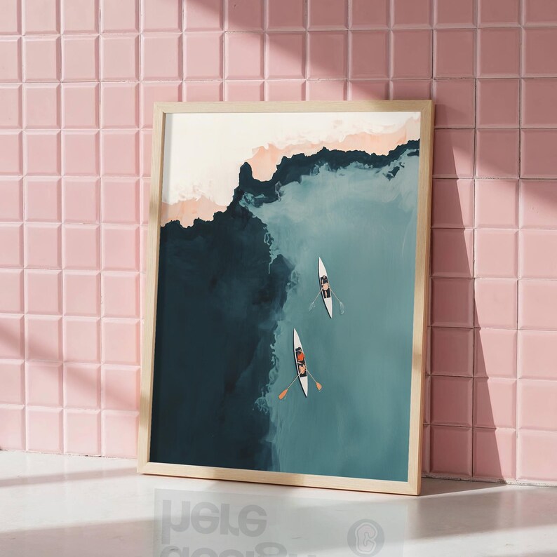 Leaning framed print against blush pink tile, aerial teal lake with rowers, rowing wall art printable