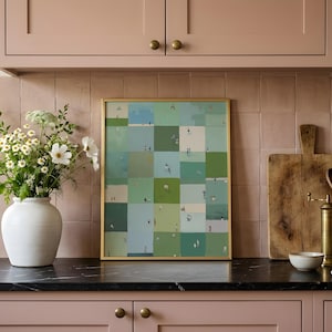 Styled on a kitchen counter between a vase and utensils, framed green grid print, sage green printable wall art, whimsical printable art
